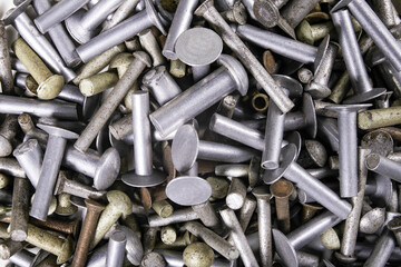 Various sizes of aluminum rivets. Accessories for joining machine parts stacked.