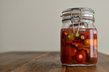 Homemade food: different kind of peppers ready to ferment in a mason jar