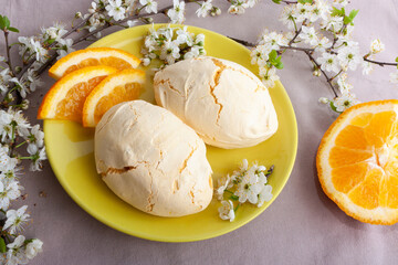 Meringue with orange on a plate