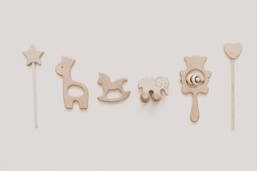 Flat lay Stylish wooden toy for kids on beige background. Gender neutral. Organic and natural toys. Eco friendly plastic free toys for toddler. Top view, card for text
