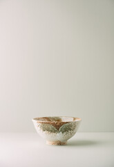 Traditional ceramic bowl on paper background. Copy space. 