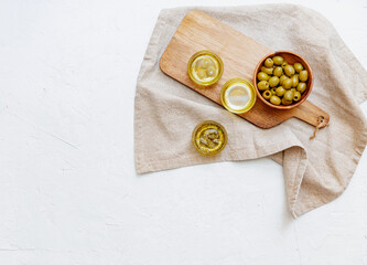 Olive oil and bread fresh branch of olives on white marble background directly above.Testing fresh olive oil.