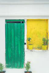 Vintage style old greek house with green door and yellow window in Sithonia, Chalkidiki.