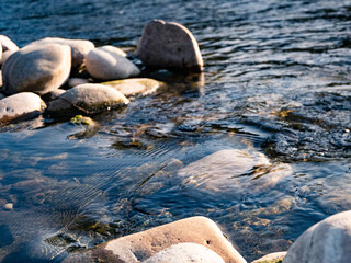 Rocks and stones in a river with very clear water surrounding it, meditation, background, calm mood, refreshing