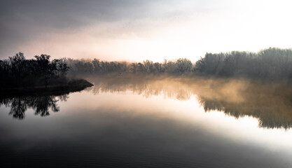 Fototapeta na wymiar Clouds Of Mist Over The Watershed Of National Park River Danube Wetlands In Austria