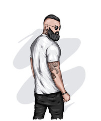 Handsome muscular guy with stylish hair, beard and tattoos. Hipster. Fashion and style, clothing and accessories.