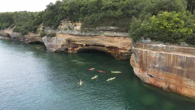 Kayaks Under Pictured Rocks Munising Michigan Drone Shot of Cliffs