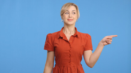 Young woman pointing at the ad space on the right of the screen. Woman making the sign to shift the...