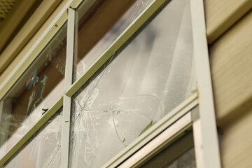 Close up of broken exterior window on white house