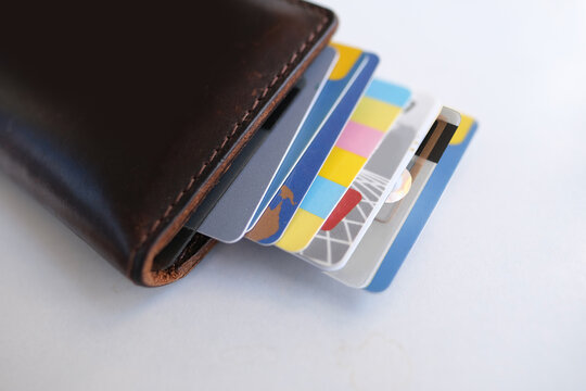 close-up of payment credit cards in a stack in a leather wallet on a white table, the concept of electronic payment, payments from bank funds, credit history, business