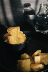 Pineapple slice under sunlight in dark background. Tropical fruits. Top view. Free space for text.