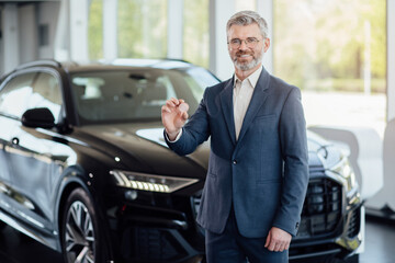 Close up male holding digital money Bitcoin to buy new car. Car exchange with Bitcoin. Cryptocurency