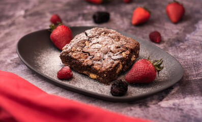 dark food dessert concept, plate with fruit brownies