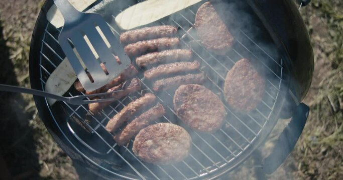 Meat grilled food grill spatula fork smoke barbeque top down close up