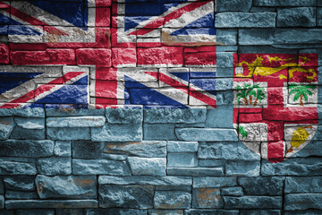 National flag of Fiji on stone  wall background.The concept of national pride and symbol of the...