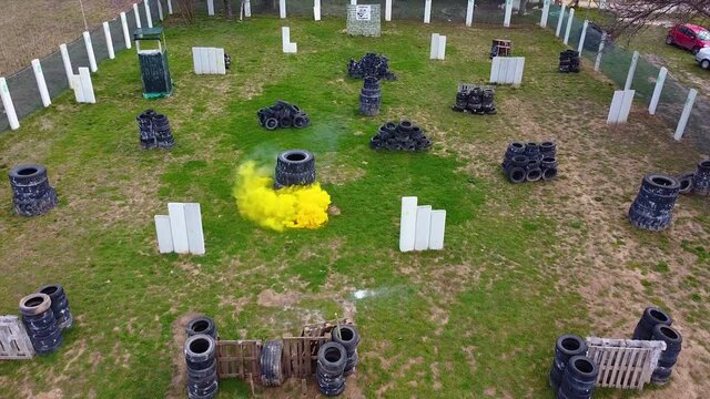 Smoke grenade goes off on a paintball field while players are playing drone shot.