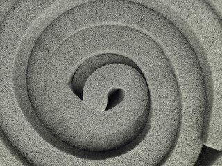 Fototapeta na wymiar the bundle of gray spongy foam is formed in a spiral
