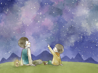 星空を見上げている父と息子