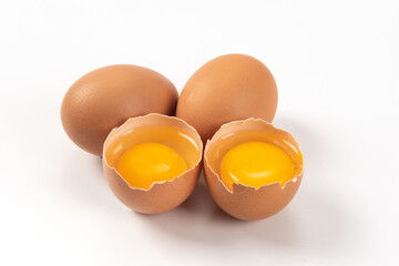 Raw brown chicken eggs on white background