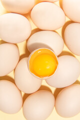 eggs and broken egg on the yellow background.
