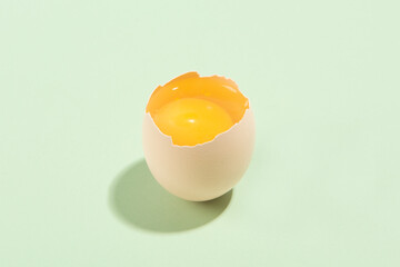 a broken egg on the green background.