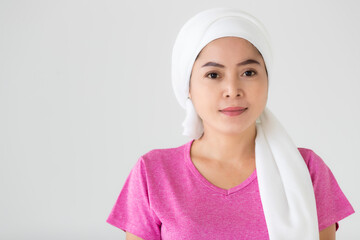 Portrait of a woman cancer patient with clothes covered around head affected from chemotherapy cure...