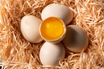 close up of raw chicken eggs in a nest