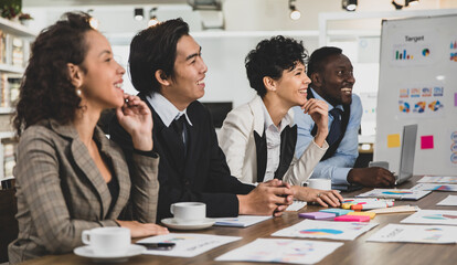 Business men and women of different nationalities were laughing, meeting happily and smiling. In the meeting room at the office. Concept happy meeting.