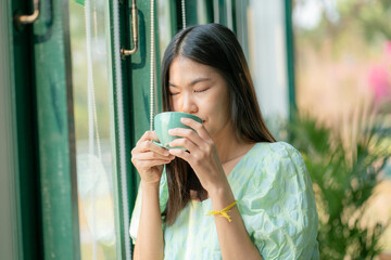Women drinking hot latte coffee ini morning aromadrink