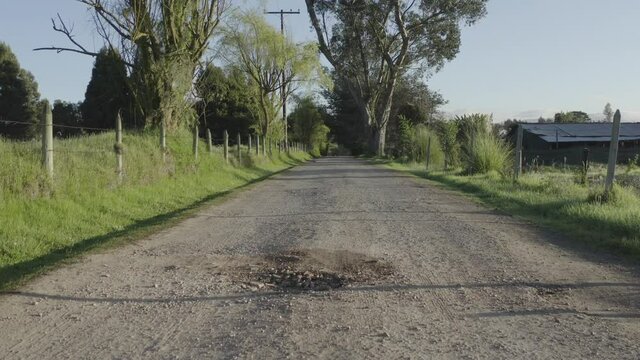 Countryside uncovered road at sunrise