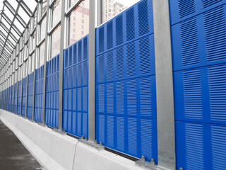 SELANGOR, MALAYSIA - JULY 5, 2020: Noise barriers are installed along the vehicle lane bordering the residence to prevent noise pollution to the surrounding locals. 