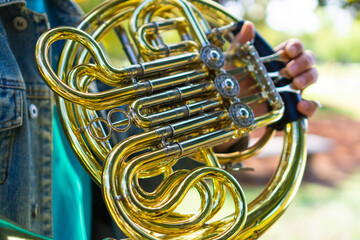 hands of a man playing a french horn, photo detail