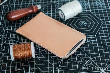 Vegetable tanned leather phone case craftmaship working with thread and tool