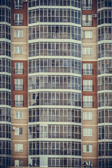 Fototapeta na wymiar the wall of a multi-storey residential building creates a beautiful repeating geometric pattern