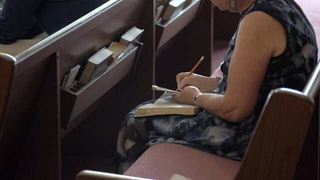 Woman taking notes in church