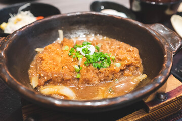 Crispy fried pork or Tonkatsu with miso sauce in the bowl. Japanese food.