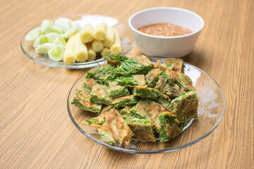 Thai food, Acacia Pennata Omelette and Shrimp-paste sauce, vegetables on wooden table background.