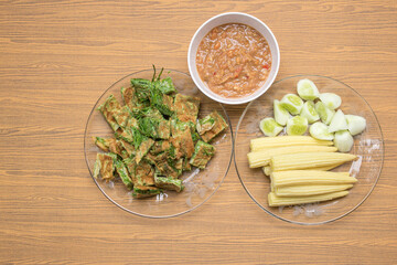 Thai food, top view of Acacia Pennata Omelette and Shrimp-paste sauce, vegetables on wooden background.