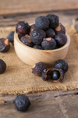Soap nuts on wooden background