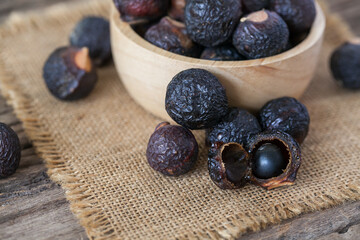 Soap nuts on wooden background