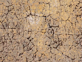 Deep cracks in the plaster. Old wall surface.