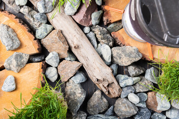 Background from a variety of stones and wood. Granite stones on the background. A podium made of stones and wood.