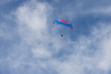 paraglider soars high in the sky