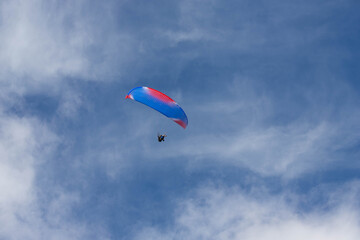 paraglider soars high in the sky