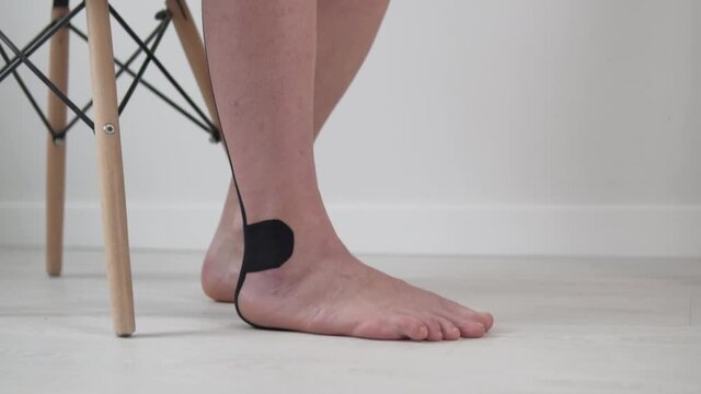A woman does an exercise to develop a foot, close-up of the foot. Exercise for rehabilitation