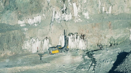 Top view of a drilling machine working in the open-pit mine