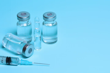 Medicine vials and syringe. Vaccination, Immunization. Fighting the coronavirus pandemic, treating pain, cancer and other diseases. Copy space