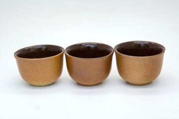 Brown tea cups on white background