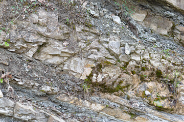 Scenic multicolor mountain nature background. Beautiful gray-orange and brown rocks. Close-up of a variegated mountain.