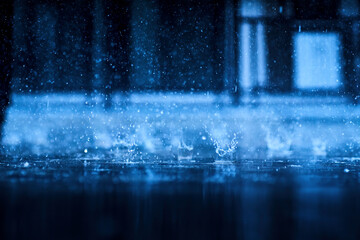 heavy raining make many small splash crown from water droplets drop down to the concrete floor in blue tone color scene